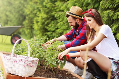 Gardener wearing protective gloves and helmet inspecting a garden site